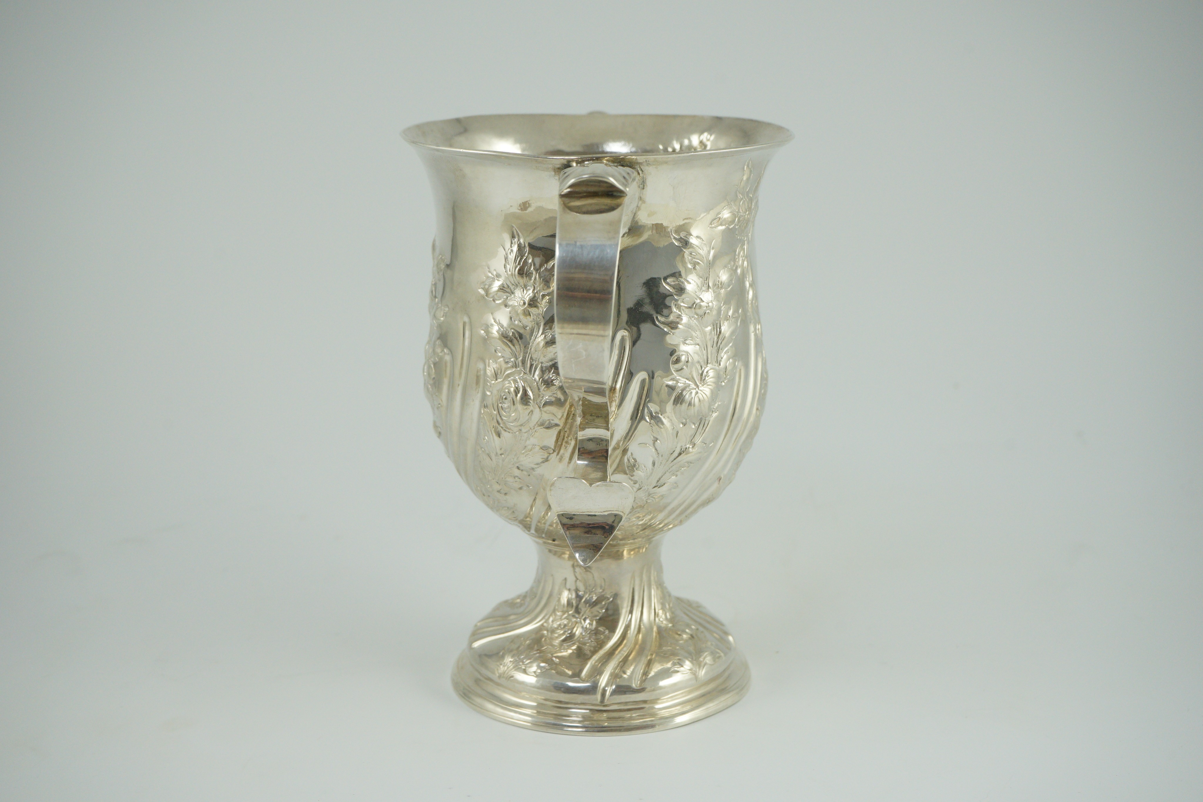 A George III silver baluster two handled pedestal cup, with later embossed decoration, by John Scofield